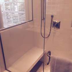 Shower with custom seat, ceramic tile and glass doors