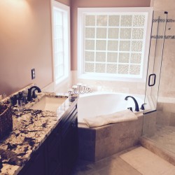 Beautiful custom bathroom with ceramic tile and granite counter tops