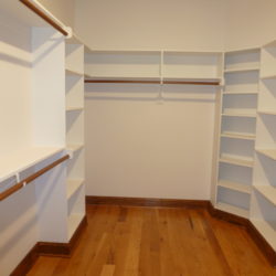 Large custom closet with handing areas and shelves